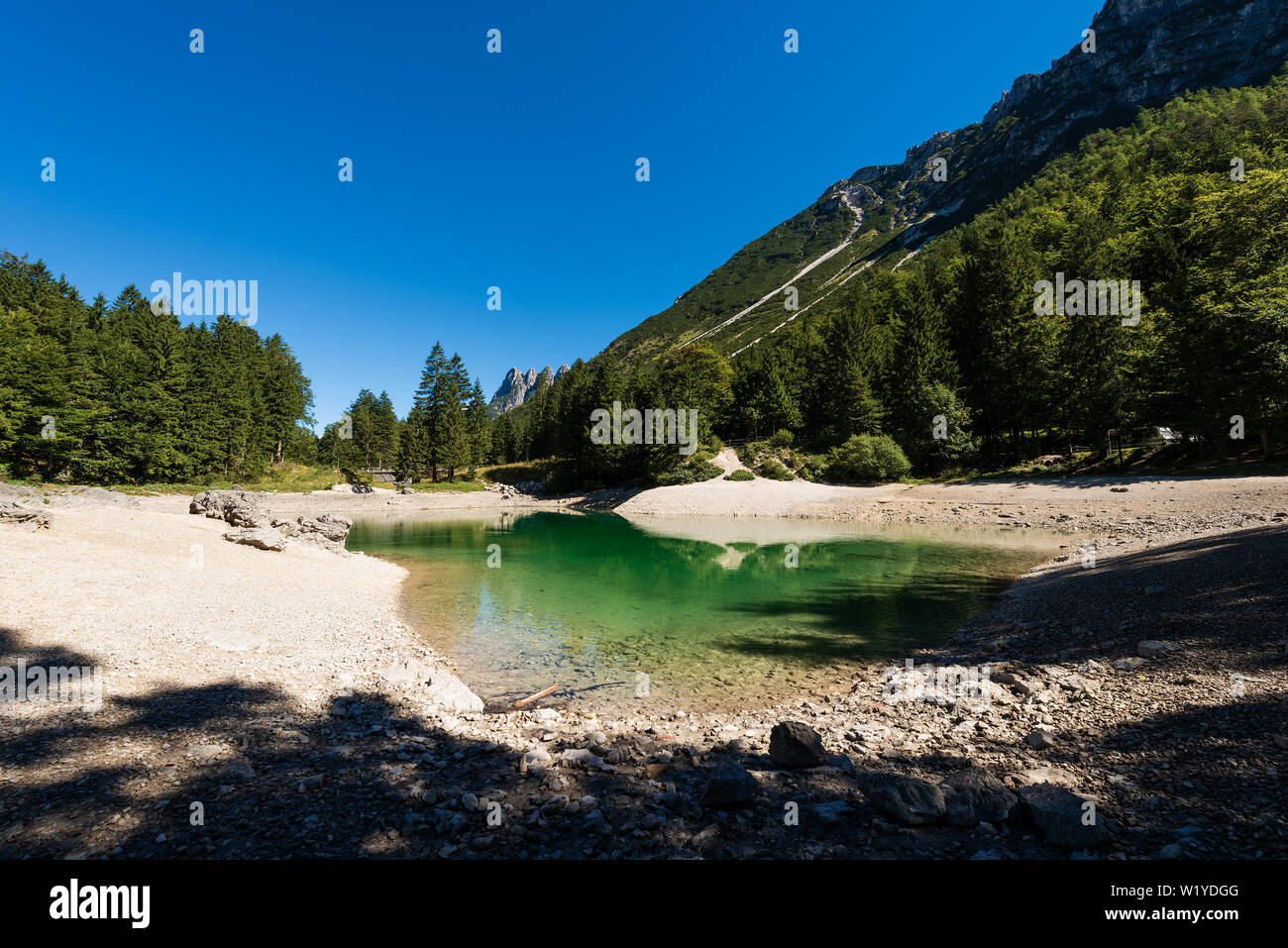 Lago del Predil, Small mountain lake in the Julian Alps, Tarvisio, Friuli Venezia Giulia, Italy, Europe. The peaks are called Cinque Punte di Raibl Stock Photo