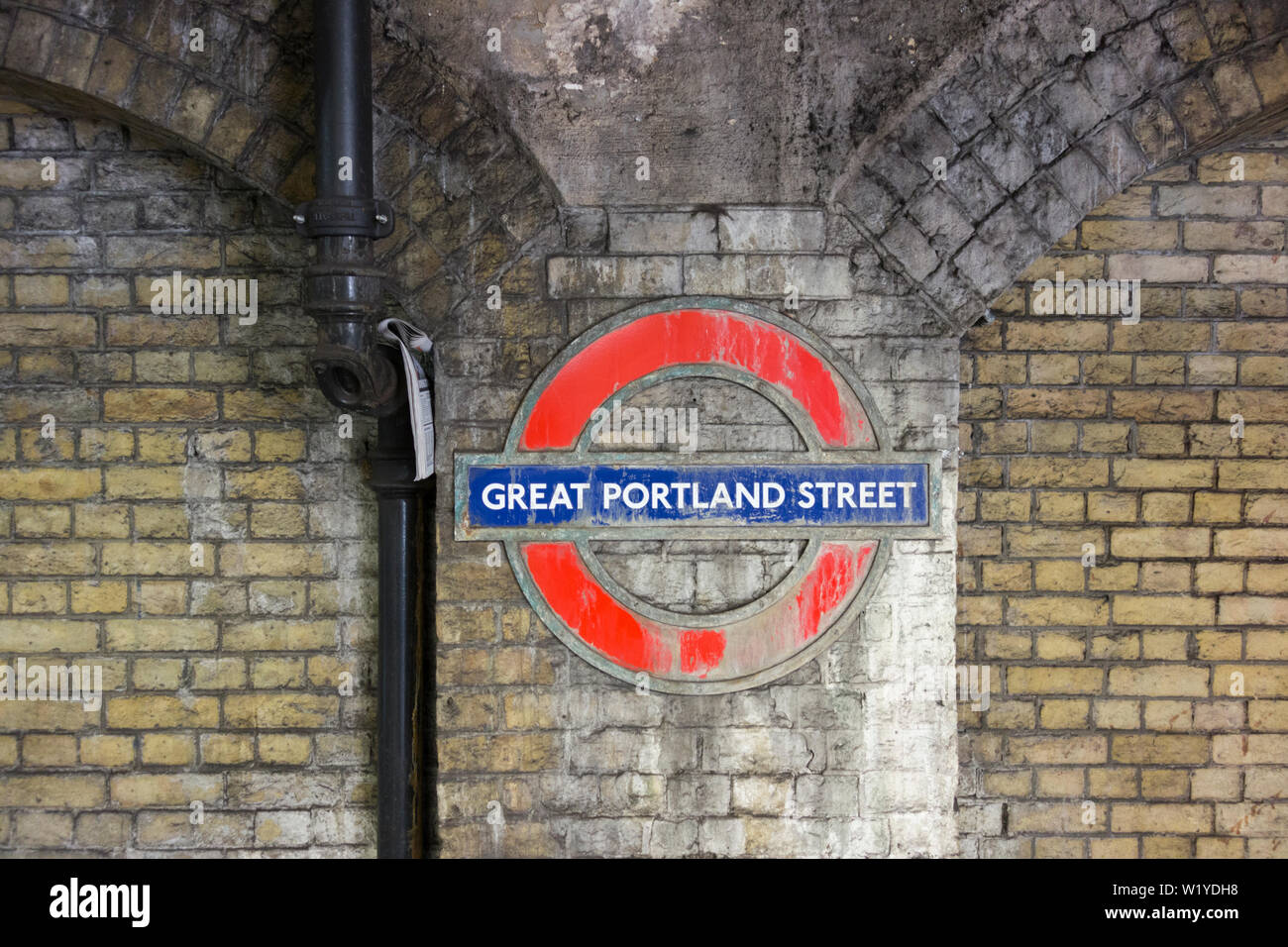 Weathered Roundel at Great Portland Street underground station, London, UK Stock Photo