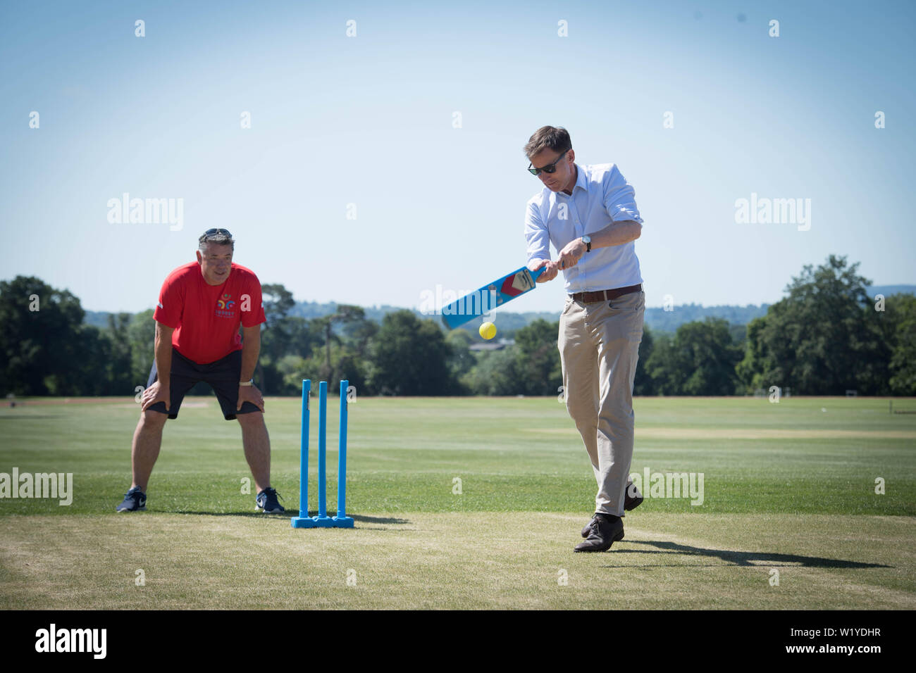 Conservative party leadership contender Jeremy Hunt tries his hand at cricket at the Surrey Para Games at the Charterhouse Club in Godalming. Stock Photo