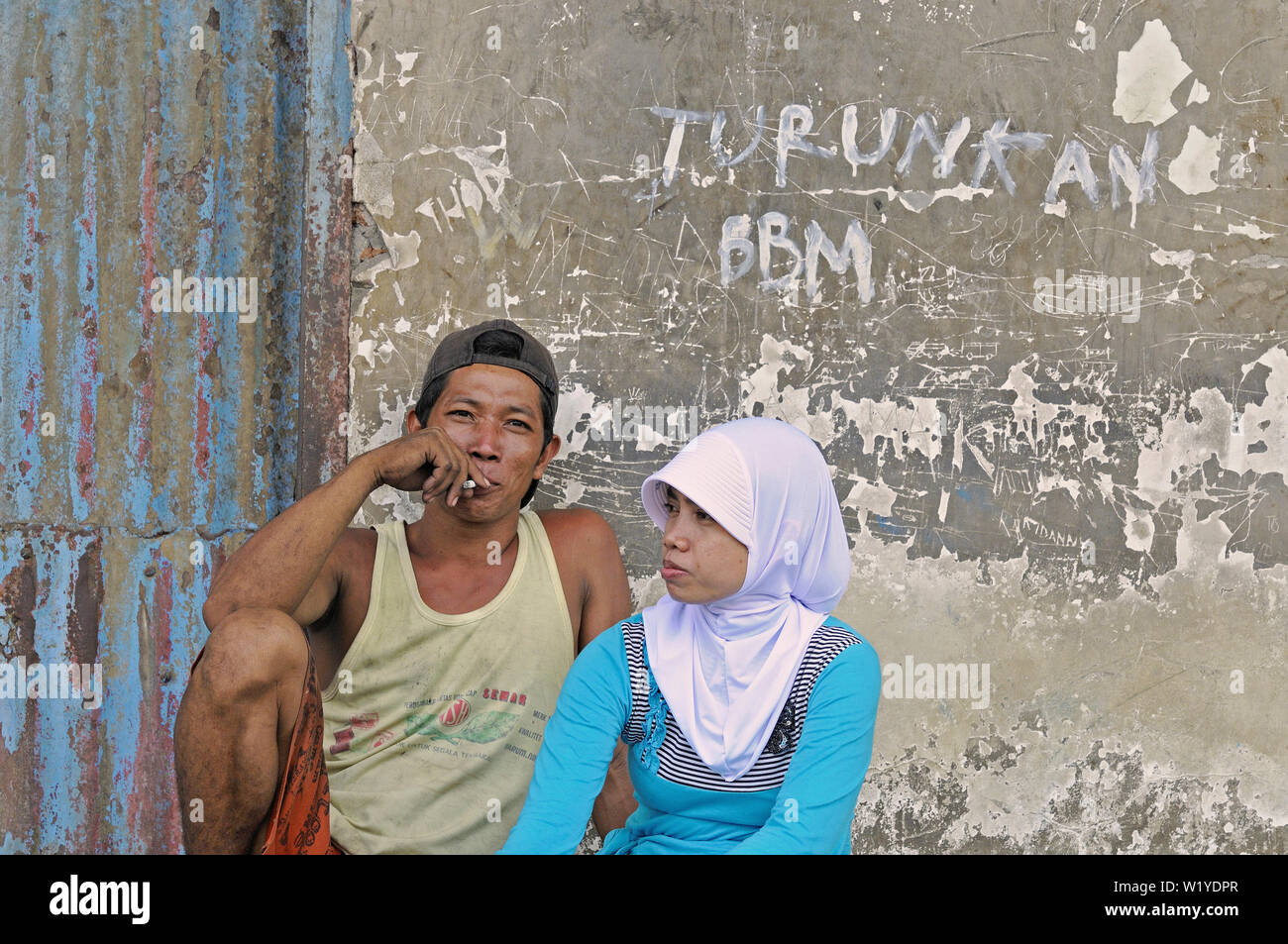 surabaya, jawa timur/indonesia - may 10, 2010: a young couple enjoying togetherness during a work break at kali mas harbour Stock Photo