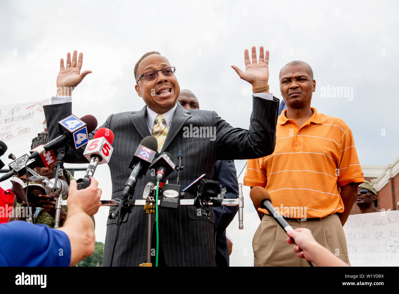 Attorney Anthony Gray does a "hands up" at a press conference in front
