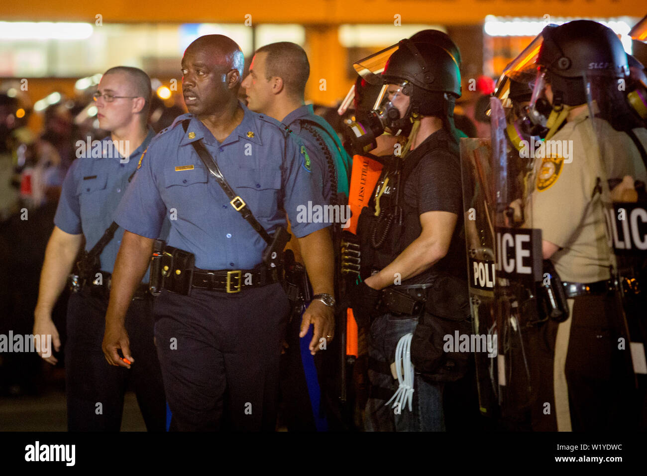 Captain Ronald Johnson of the Missouri State Highway Patrol walks and talks with the protesters in an attempt to de-escalate the tensions following the riots and protests after the killing of Michael Brown. Stock Photo