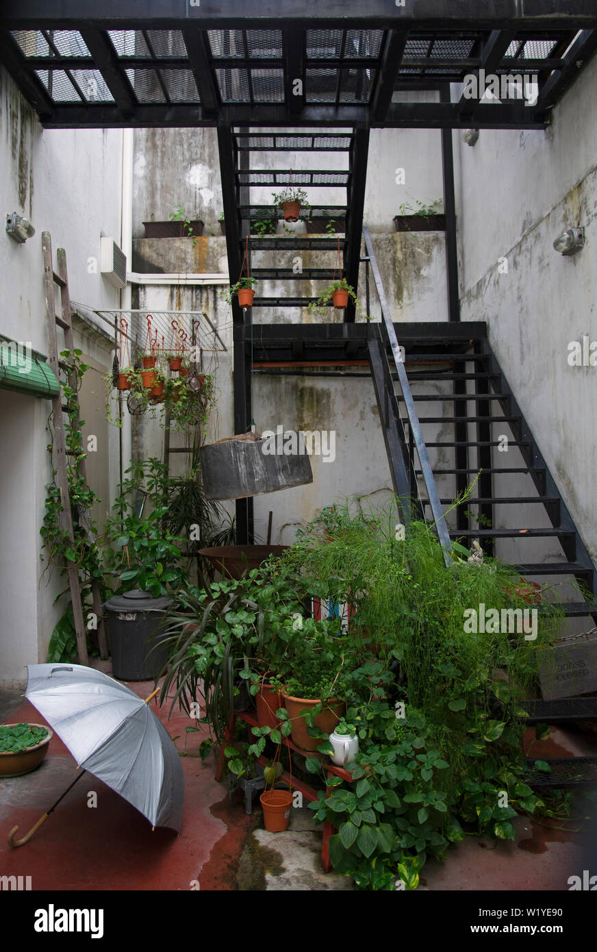 george town, penang/malaysia - february 23, 2017: idyllic garden backyard / patio of a cafe on lebuh penang with stairs Stock Photo
