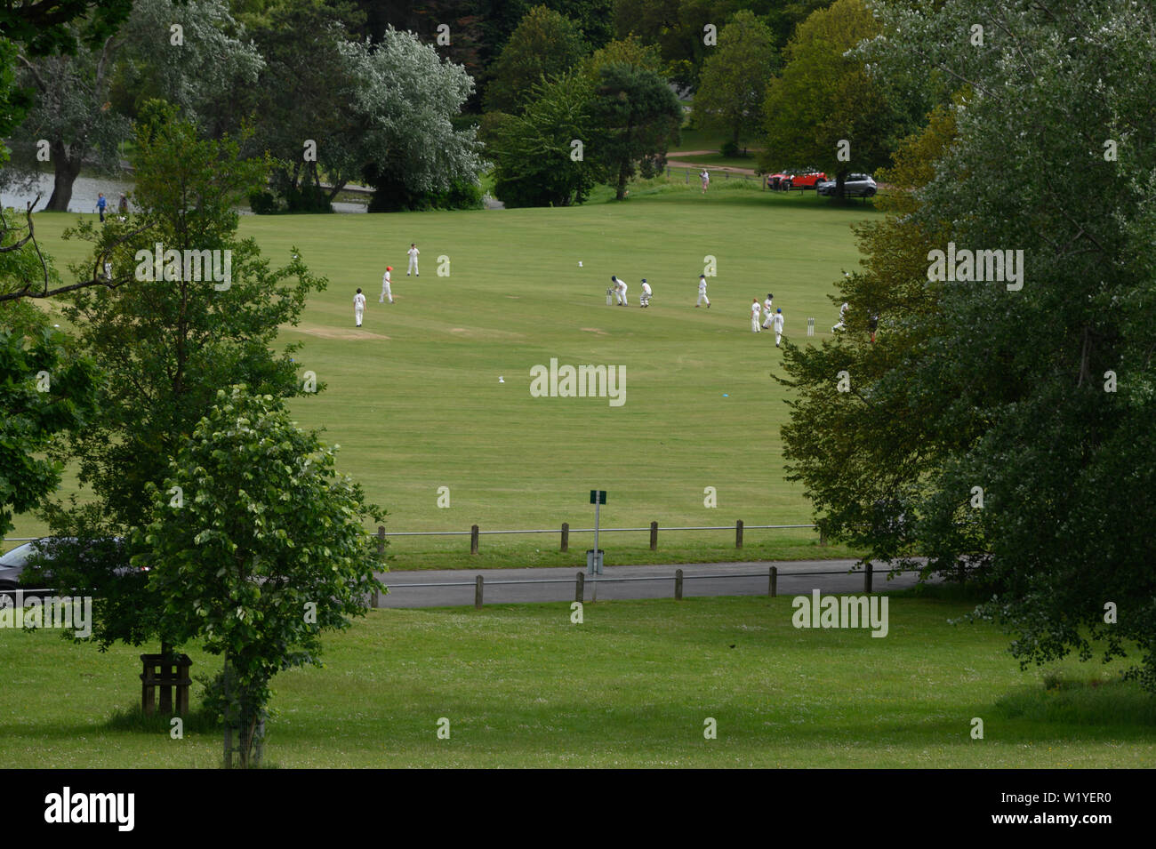 English cricketers playing on a field in the countryside Stock Photo