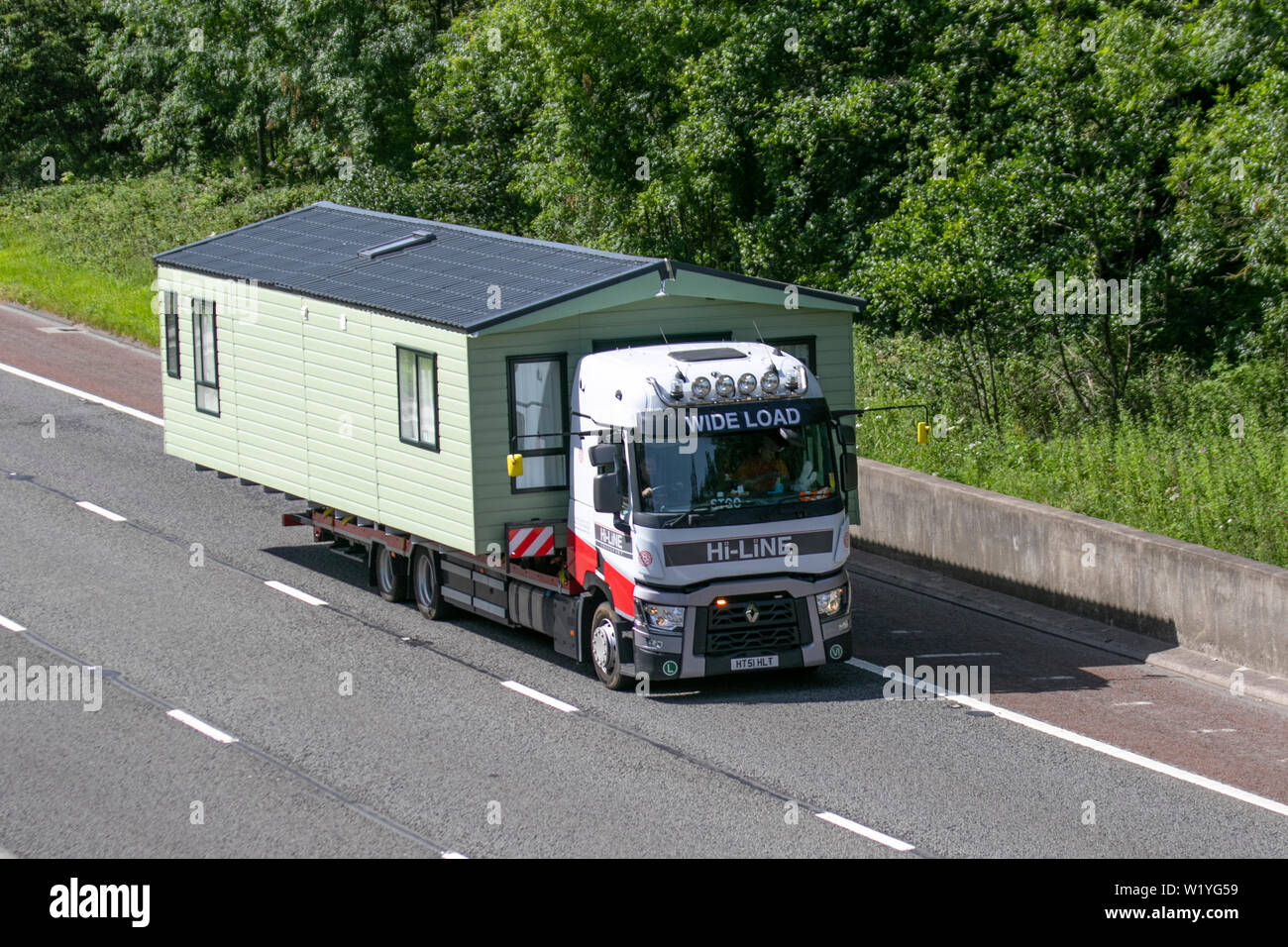 Merceders-Benz Hi-Line and modular housing static caravans on trailer; Commercial vehicles on the M6 at Lancaster. UK Stock Photo
