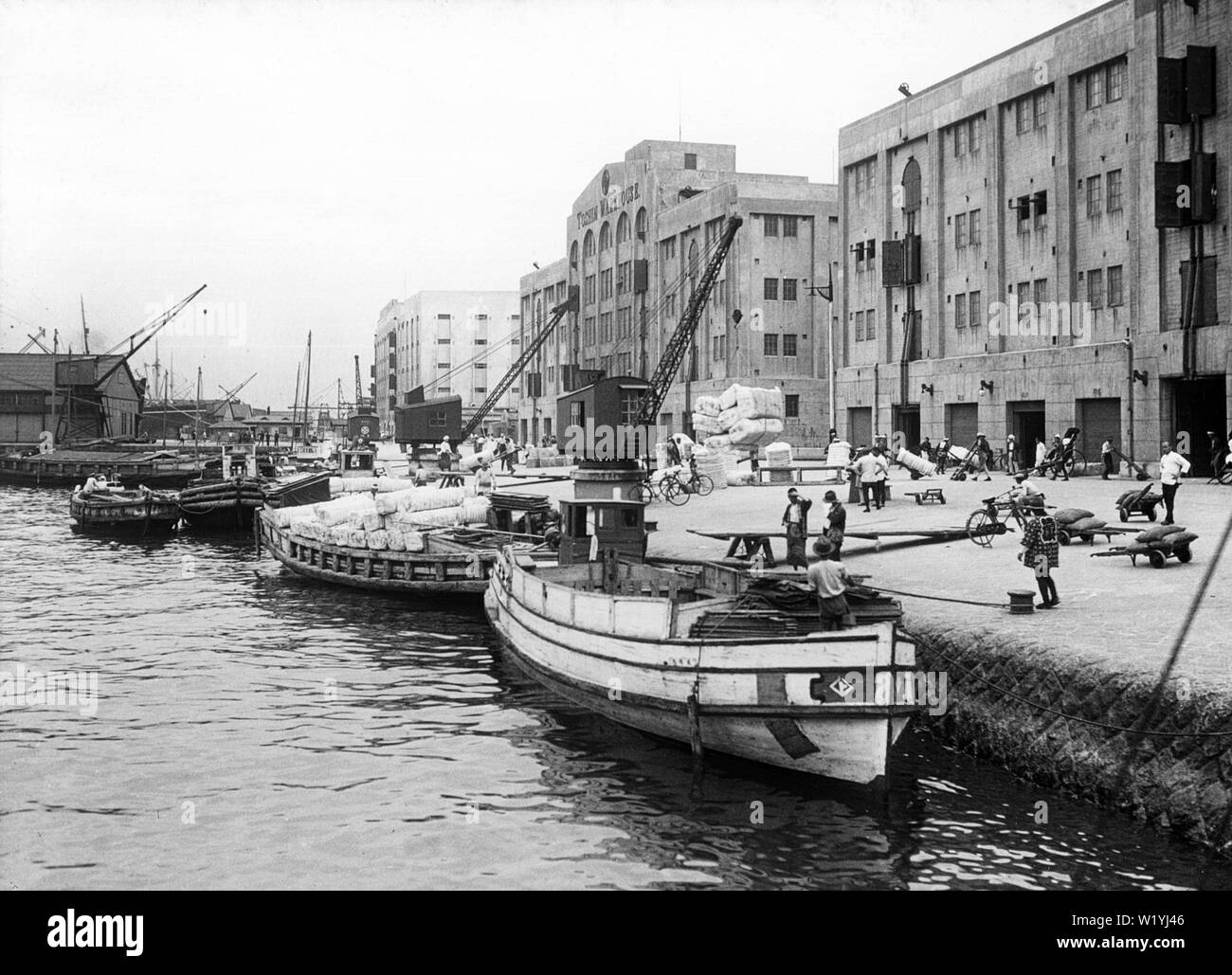 [ 1930s Japan - Kobe Harbor ] —   Warehouses and boats at Kobe Harbor, 1930 (Showa 5).  20th century vintage glass slide. Stock Photo