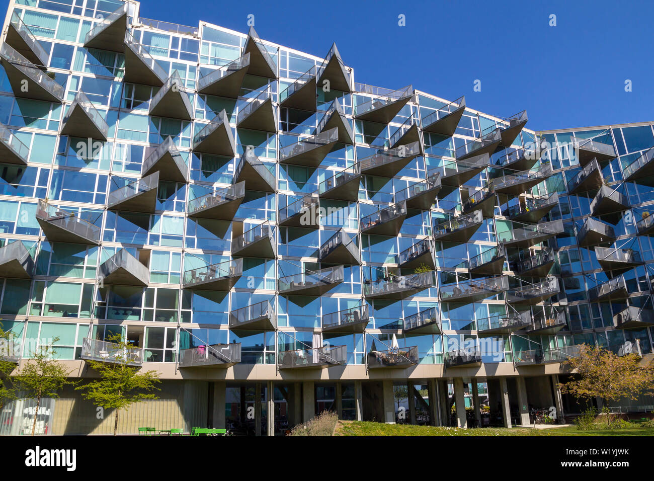 Modern architecture building in Orestad, Copenhagen, with triangular balconies in a glass facade Stock Photo