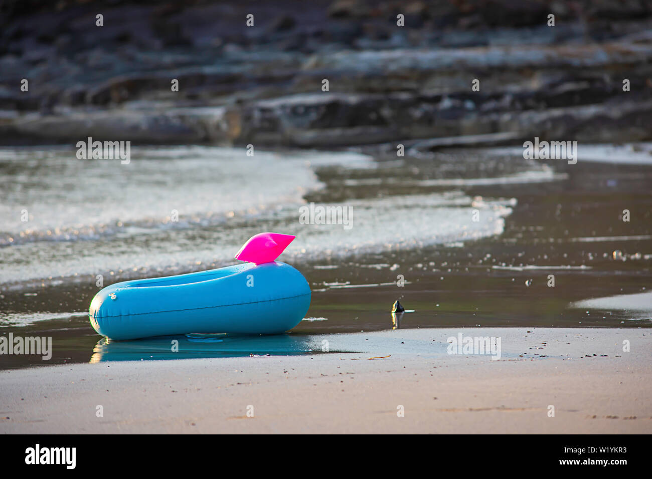 Blue Inflatable ring on the beach Background sea. Stock Photo