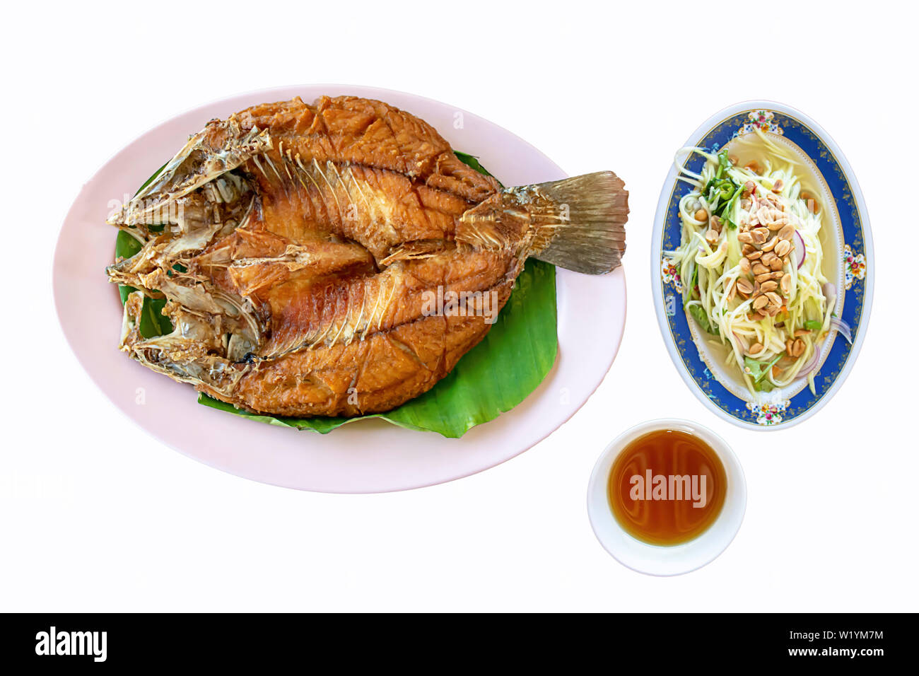 Isolated fried snapper fish With seafood sauce and vegetables  in dish on a white background with clipping path. Stock Photo