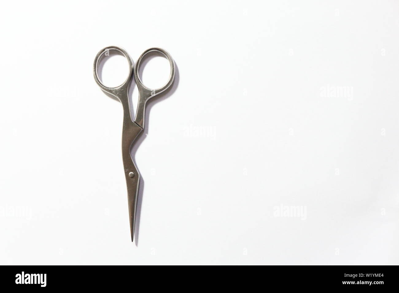 Little scissors to have eyebrow done isolated on white background Stock ...