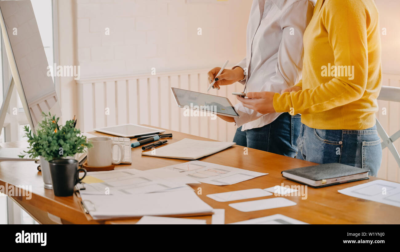 Snap shot web designer working on office desk, site wireframe sketch