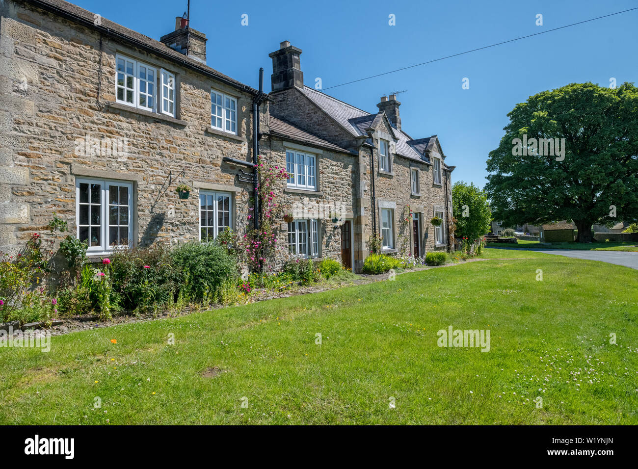 Local stone built housing in the Yorkshire Dales village of Redmire, England, UK. Stock Photo