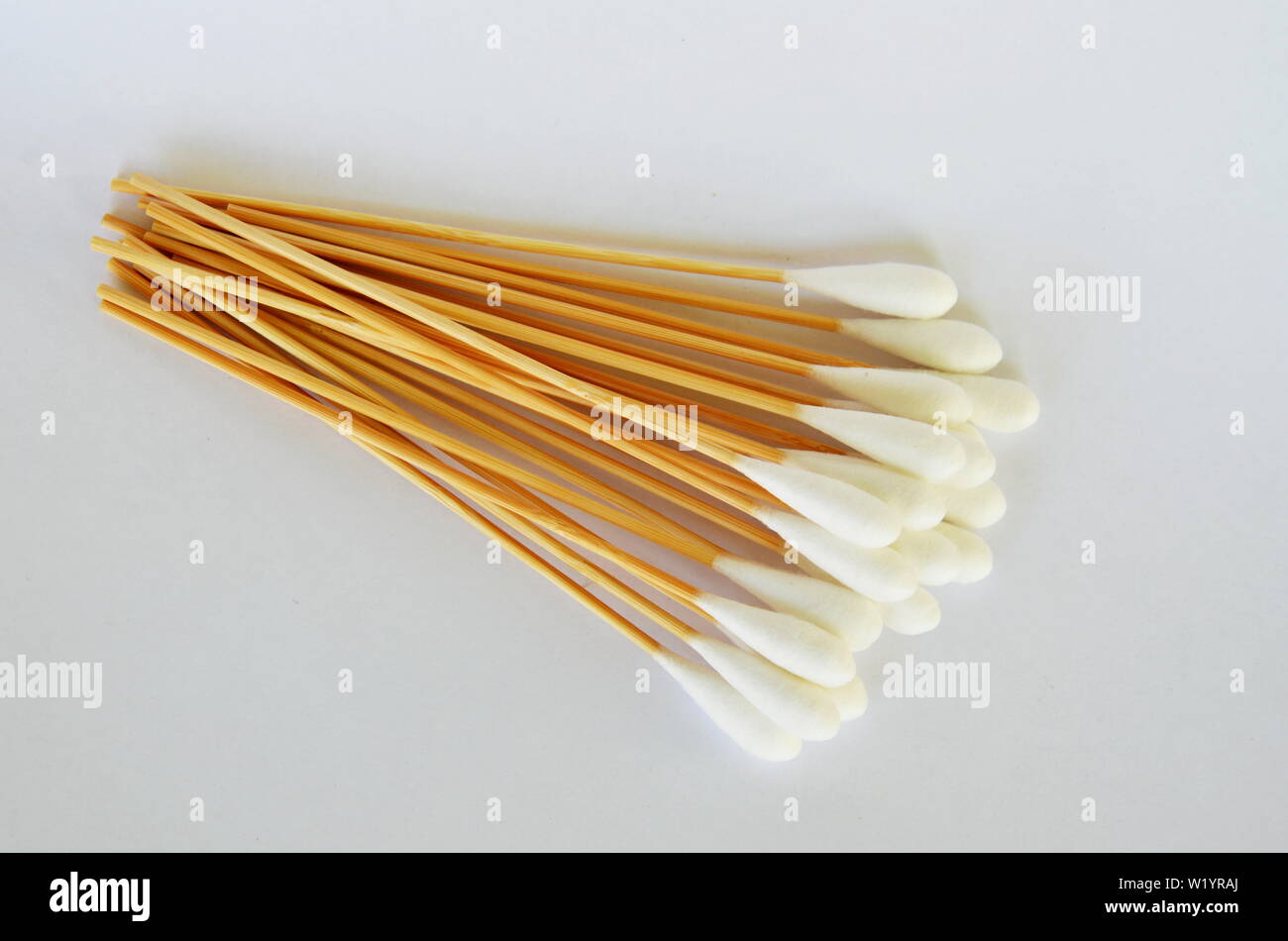 cotton bud with long wooden stick on white background Stock Photo Alamy