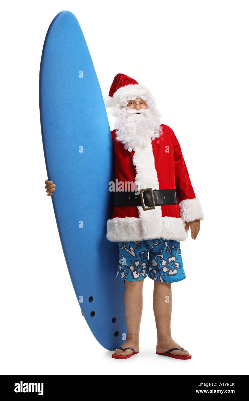 Full length portrait of santa claus wearing swimming shorts and holding a surfing board isolated on white background Stock Photo