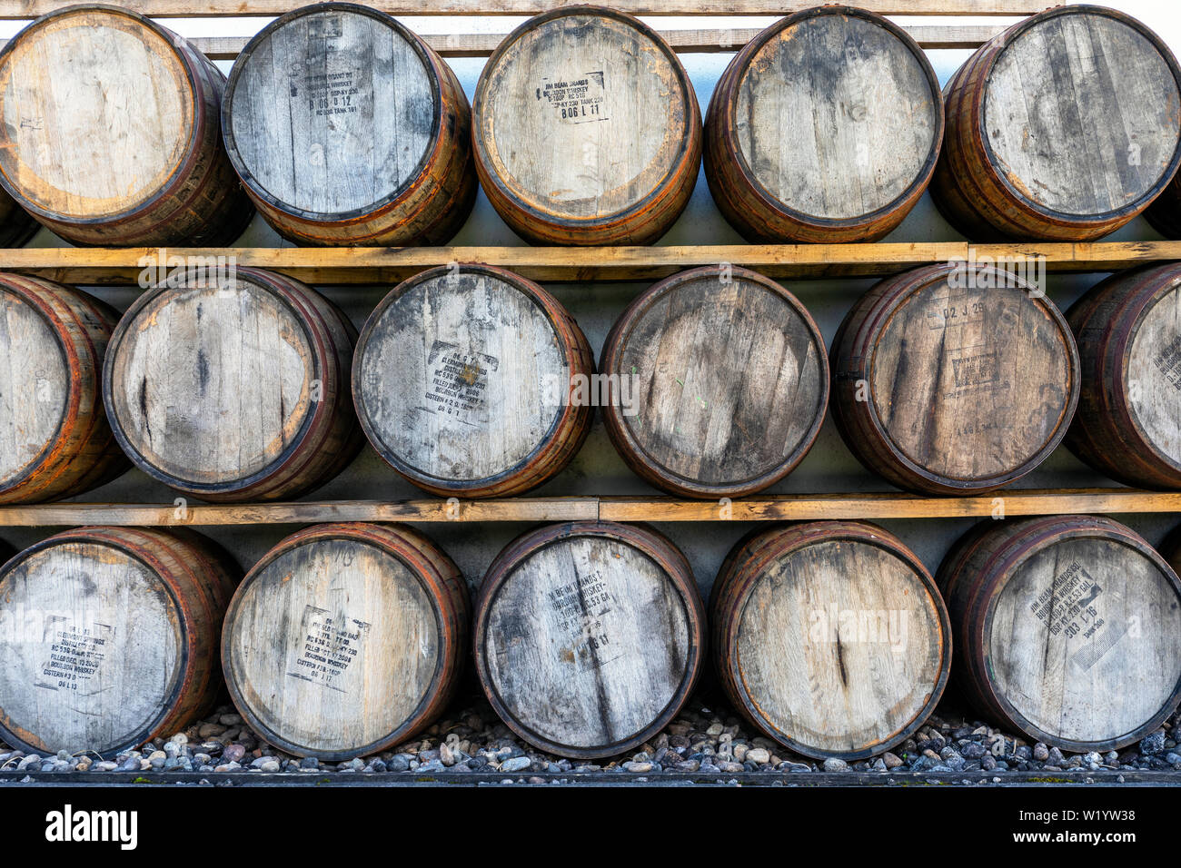 stacked whisky barrels at the Arran distillery, Lochranza, Isle of Arran, Scotland Stock Photo