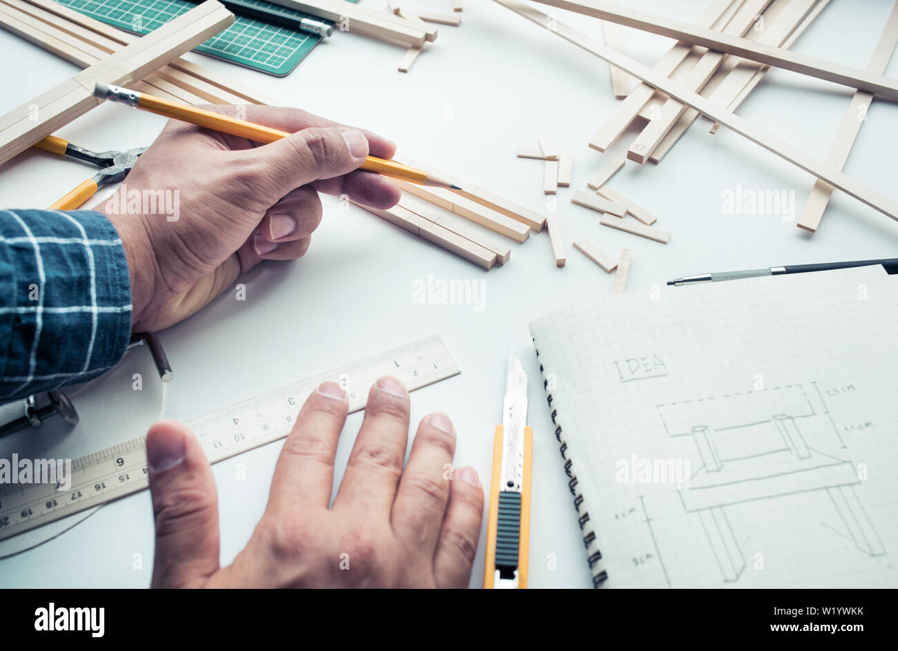 Male working on worktable with balsa wood material.Diy,design project,invention concept ideas Stock Photo