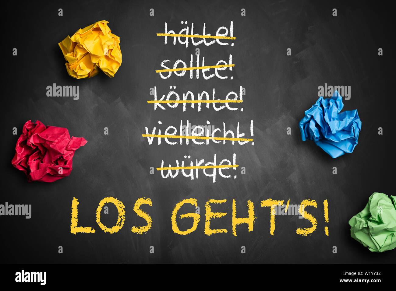 chalkboard with crumpled paper and stroked words like could and should