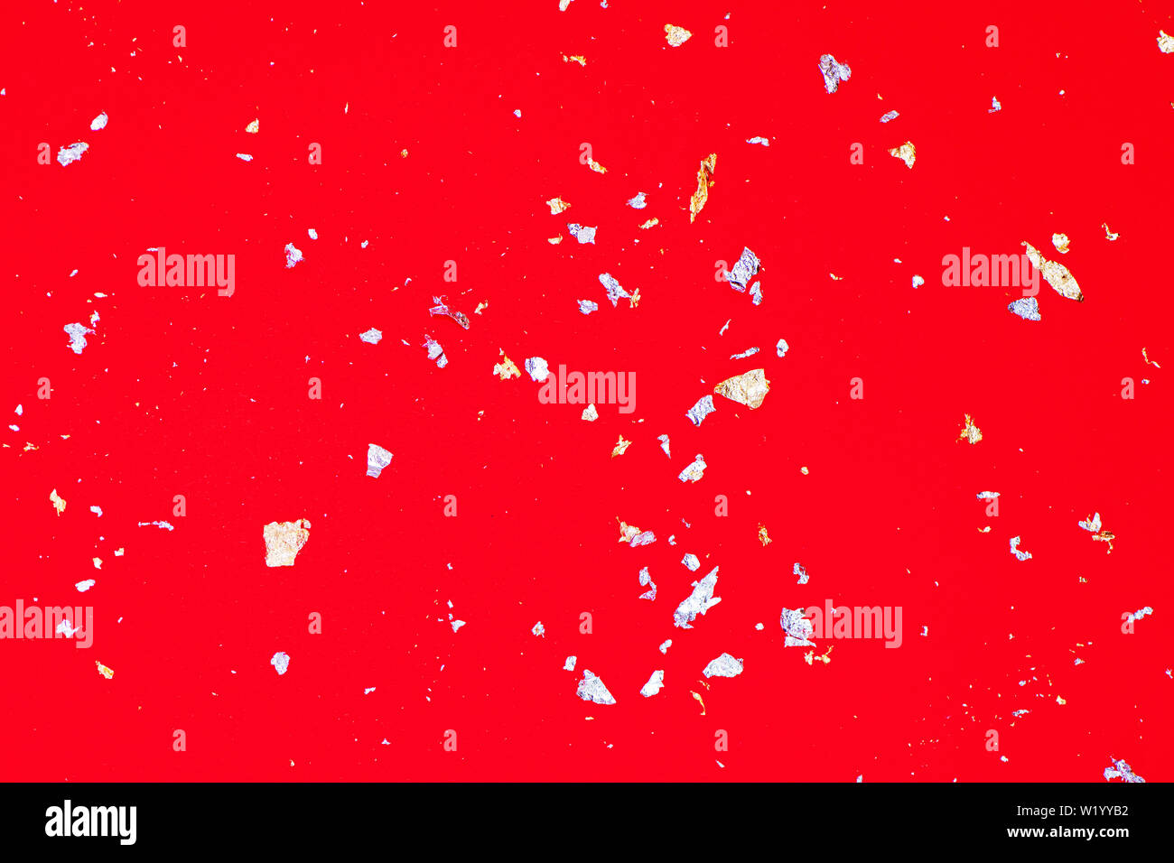 Golden and silver sparkles on bright red background. Festive background for your projects. Stock Photo