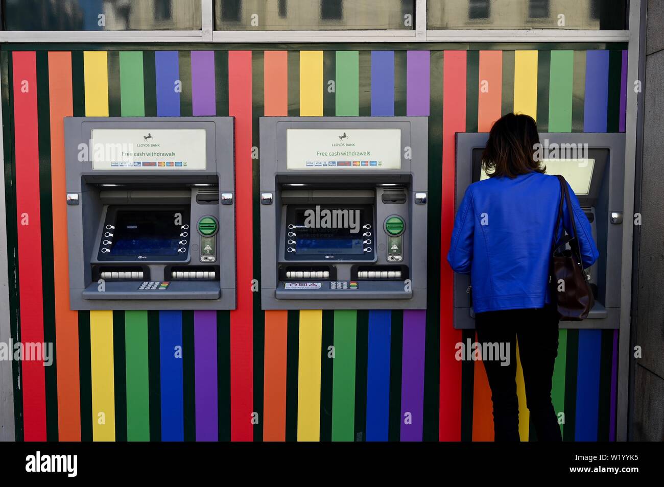 Rainbow cash machine. Shops and businesses display rainbow colours prior to the Pride in London Celebrations this weekend. London. UK Stock Photo