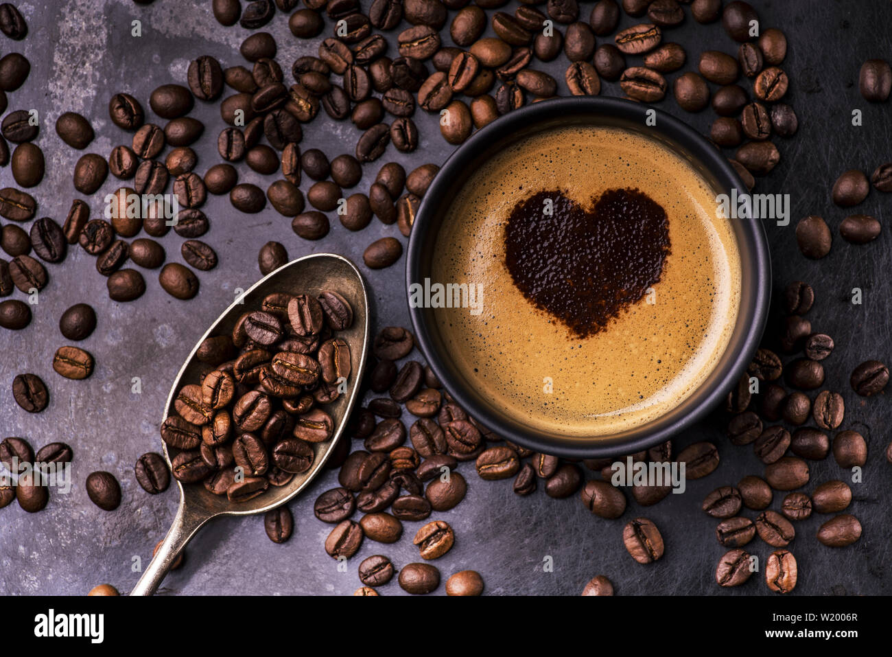silhouette of a heart drawn with cocoa in a cup of black coffee Stock Photo