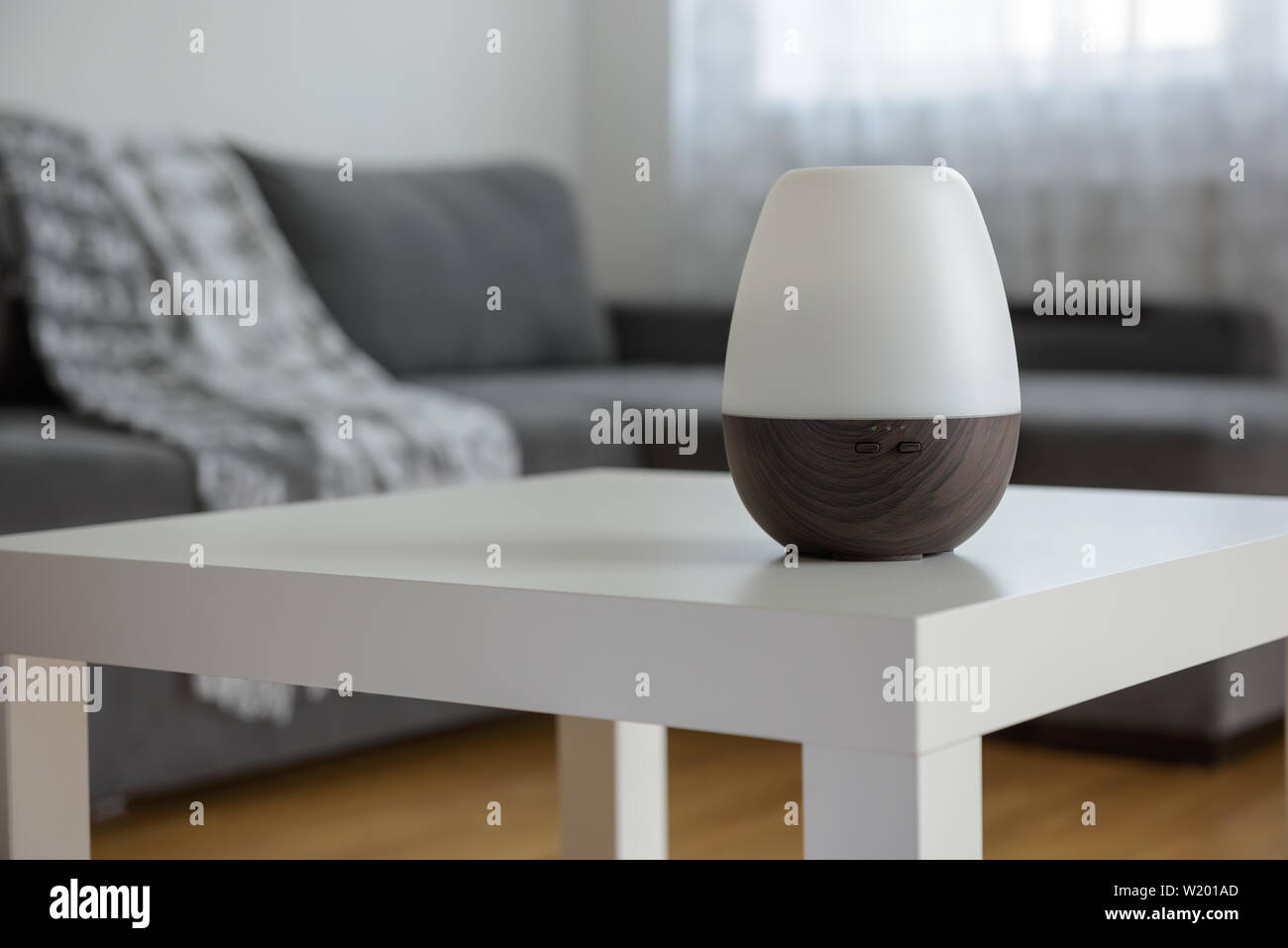 Essential Oil Diffusers on a white table on the background of the interior. Stock Photo