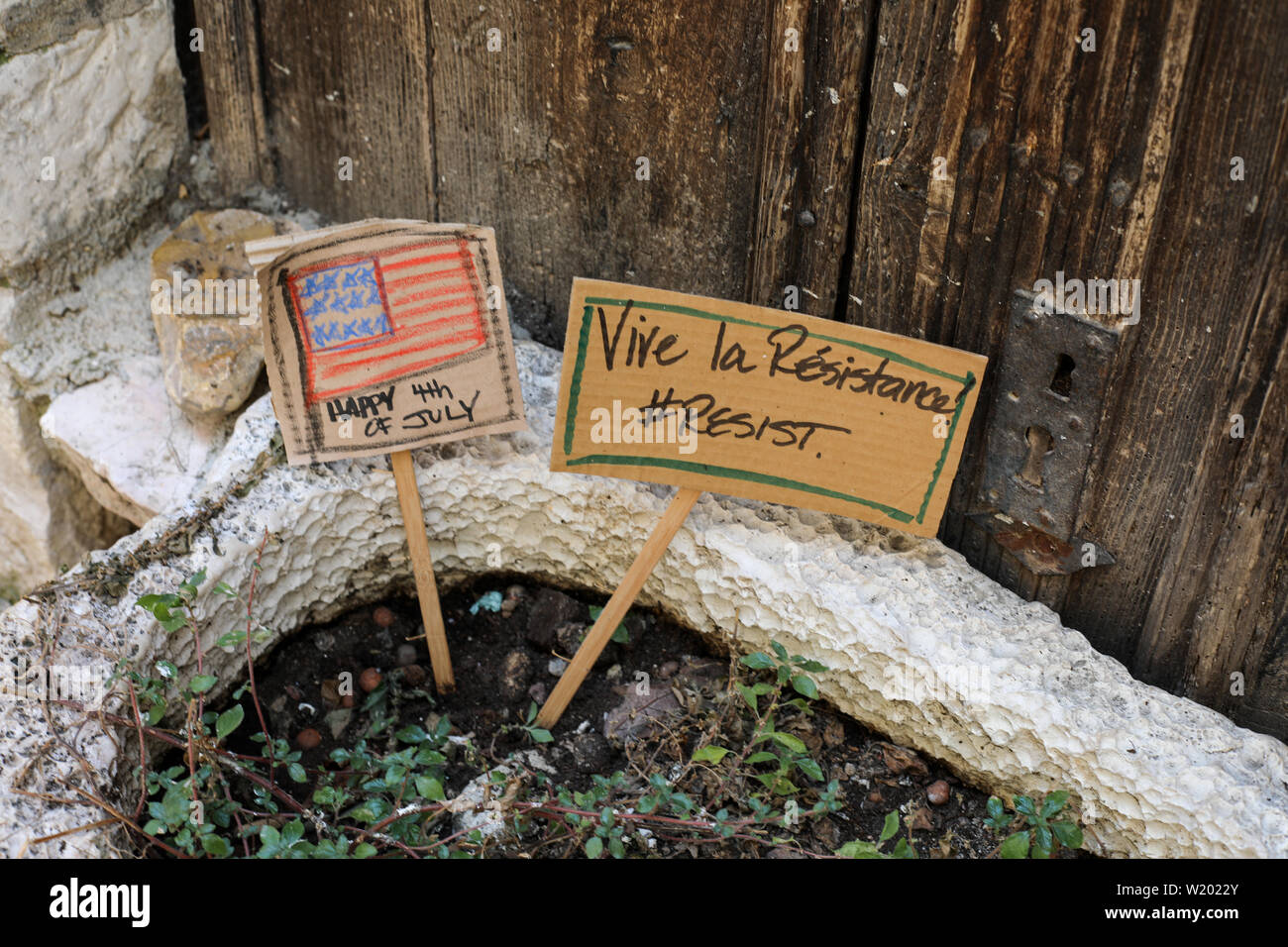 Cardboard signs on a flower pot in Saint-Paul-de-Vence, France Stock Photo