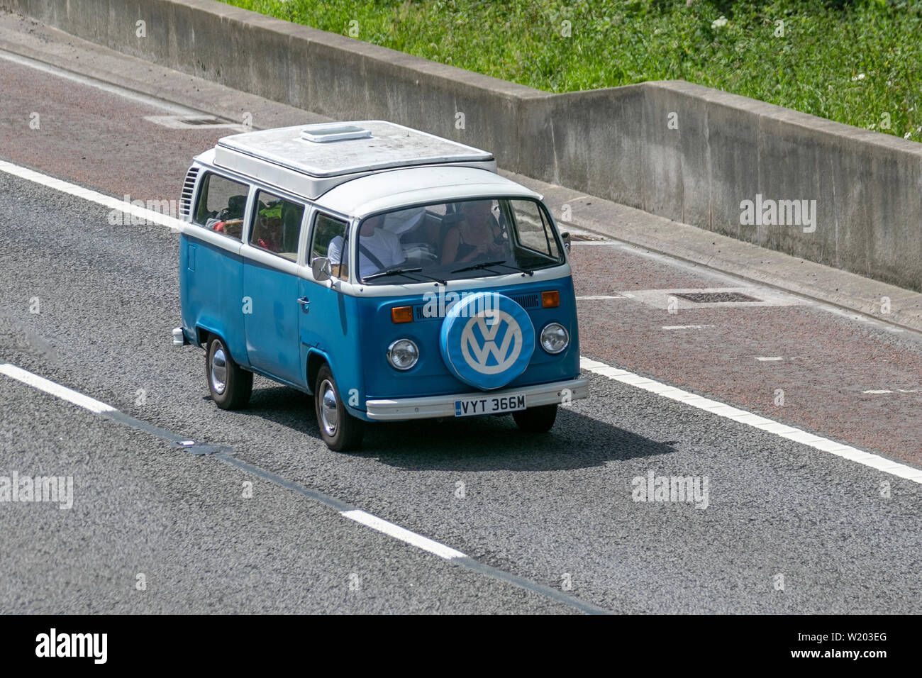 Blue white VW Volkswagen Motor Caravan; UK Vehicular traffic, transport, modern, saloon cars, north-bound on the 3 lane M6 motorway highway. Stock Photo