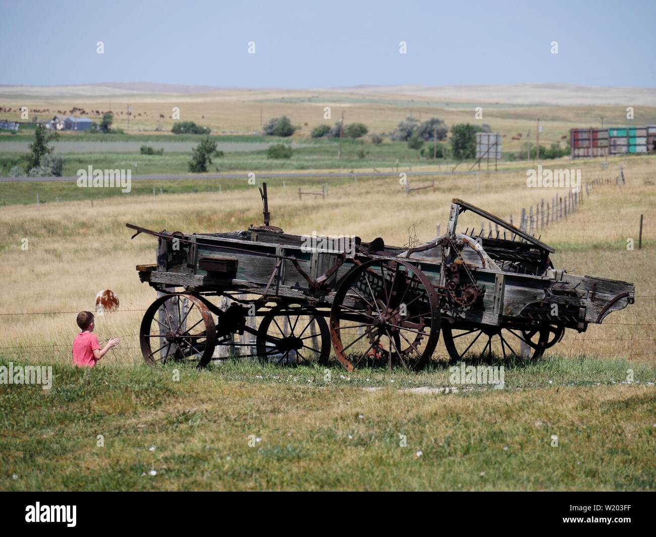 Murdo, South DakotaJuly 2018 A boy stands beside a dilapidated