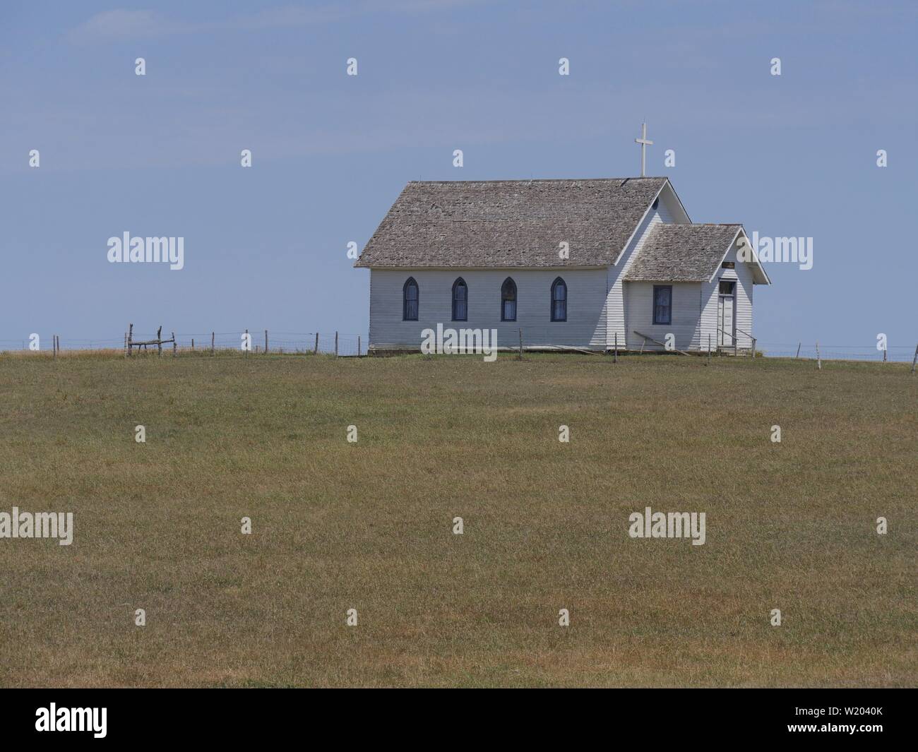 Medium wide shot of a Presbytheran church building outside an 1880s ...