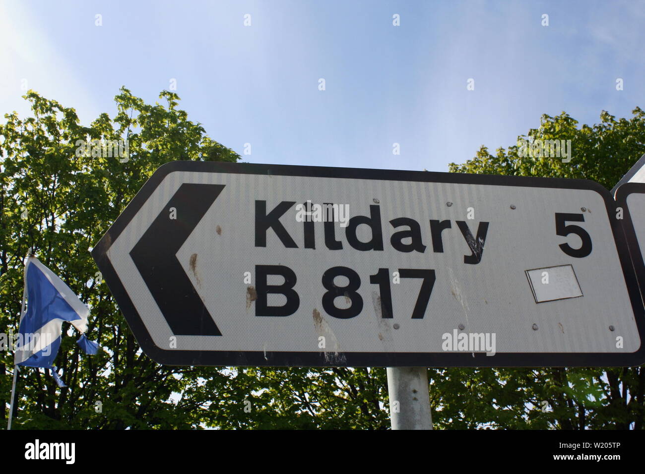Sign giving the direction and distance to Kildary, Scotland, United Kingdom Stock Photo