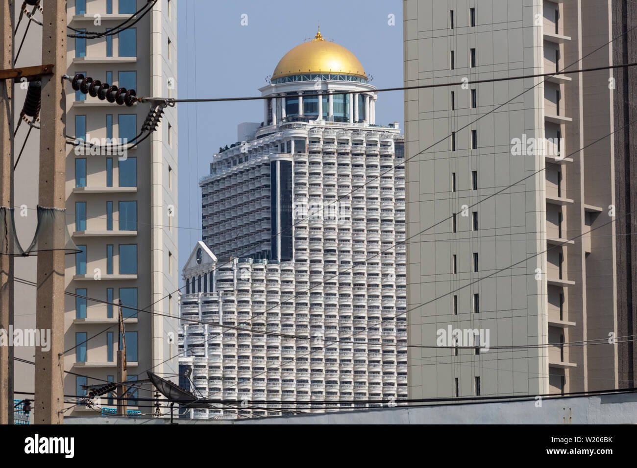 Bangkok, Thailand - April 14, 2019:  State tower skyscraper seen in between other buildings Stock Photo