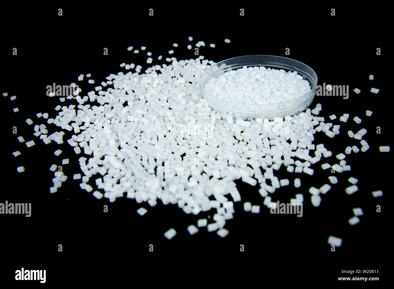 Transparent Polypropylene, polypropene, polystyrene, polyethylene, thermoplastic polymer, HDPE and plastic raw material pellets or granules. Stock Photo