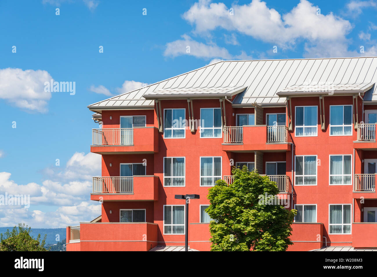 Top of residential building on blue sky background Stock Photo - Alamy