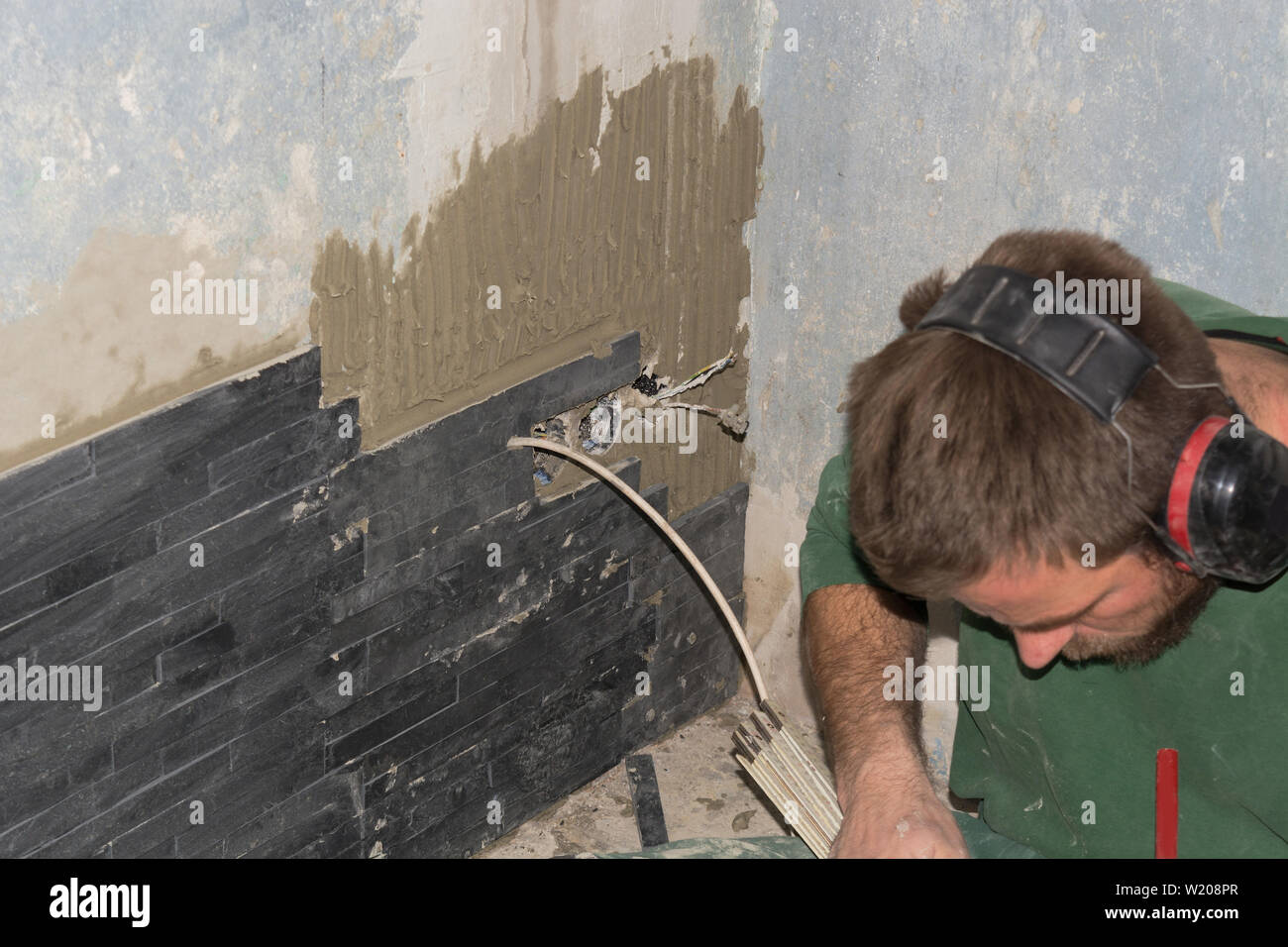 Tiler install ceramic retro straps clinker tiles Stock Photo