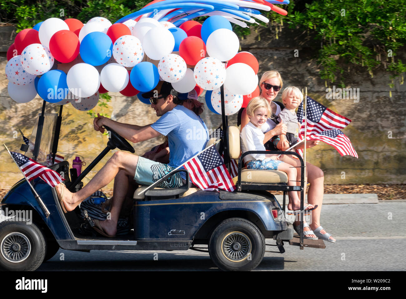 Sullivans Island South Carolina, USA. 4th July, 2019. A golf cart float decorated in balloons and flags during the annual Independence Day parade July 4, 2019 in Sullivan's Island, South Carolina. The tiny Sea Island beach community across from Charleston, was once a quarantine station for enslaved Africans, and is now one of the most affluent, least diverse communities with one of highest per capita real estate costs in the United States. Credit: Planetpix/Alamy Live News Stock Photo