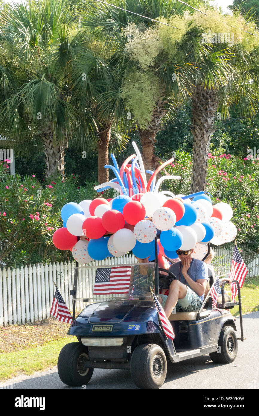 Sullivans Island South Carolina, USA. 4th July, 2019. A golf cart float decorated in balloons and flags during the annual Independence Day parade July 4, 2019 in Sullivan's Island, South Carolina. The tiny Sea Island beach community across from Charleston, was once a quarantine station for enslaved Africans, and is now one of the most affluent, least diverse communities with one of highest per capita real estate costs in the United States. Credit: Planetpix/Alamy Live News Stock Photo
