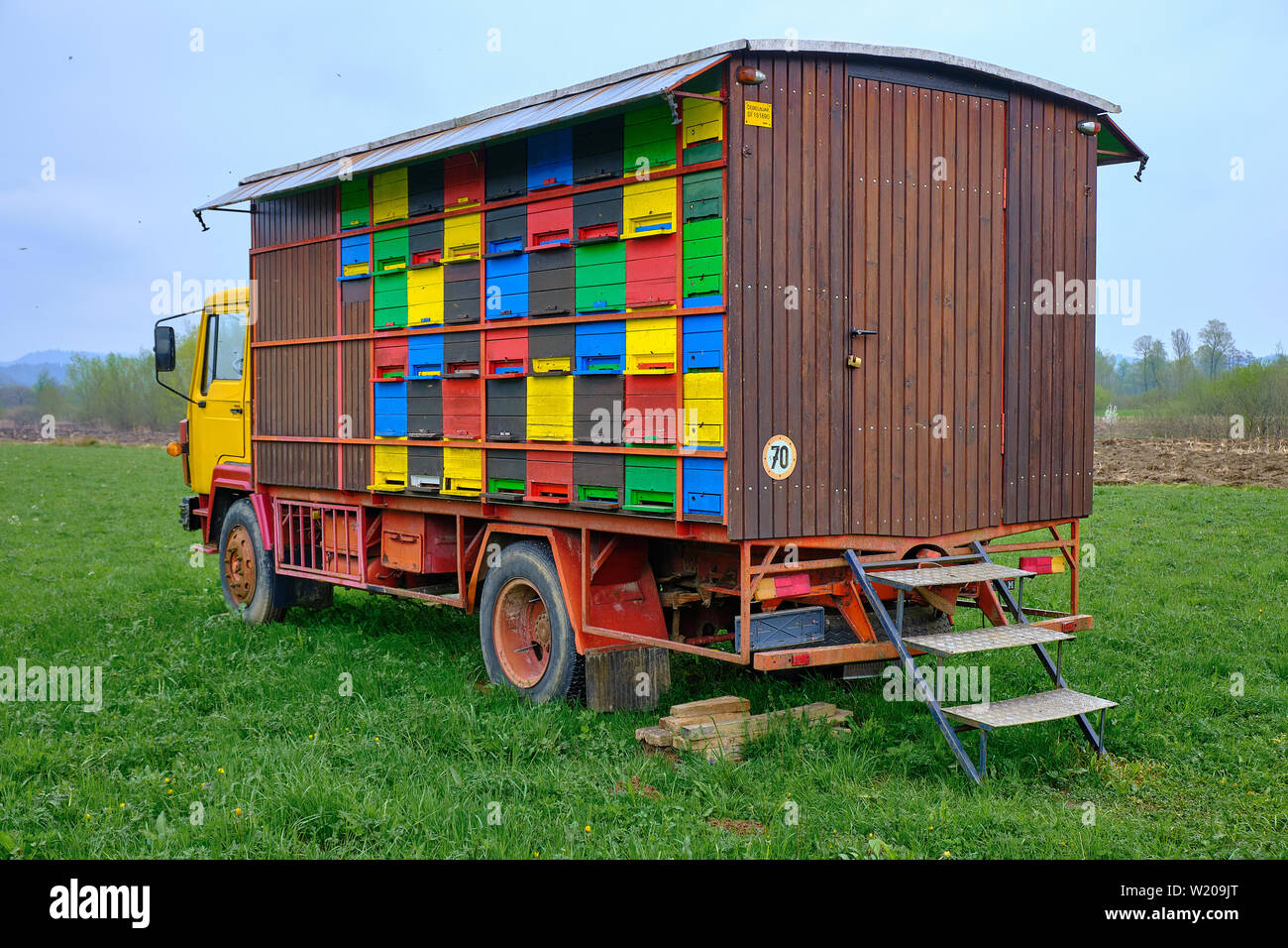 Mobile beehives on a truck, stationed in field.  Rural Slovenia, Stock Photo