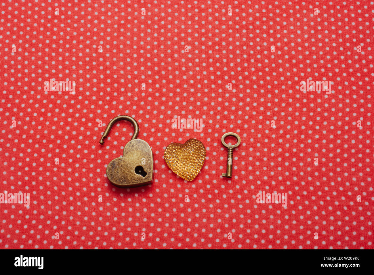 Heart shaped lock and key on a red background Stock Photo - Alamy