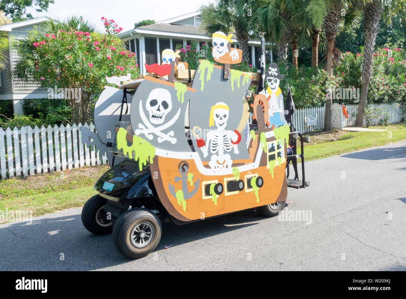 Sullivans Island South Carolina, USA. 4th July, 2019. A golf cart float decorated as a pirate ship rides down the road during the annual Independence Day parade July 4, 2019 in Sullivan's Island, South Carolina. The tiny affluent Sea Island beach community across from Charleston holds an outsized golf cart parade featuring more than 75 decorated carts. Credit: Planetpix/Alamy Live News Stock Photo