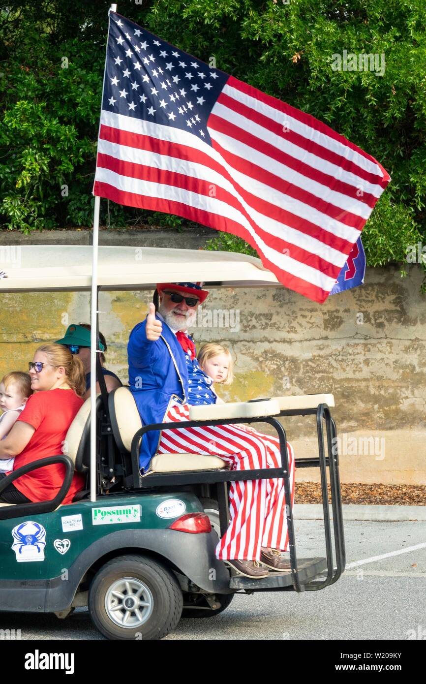 Sullivans Island South Carolina, USA. 4th July, 2019. Uncle Sam gives a thumbs up from the back of a decorated golf cart during the annual Independence Day golf cart and bicycle parade July 4, 2019 in Sullivan's Island, South Carolina. The tiny affluent Sea Island beach community across from Charleston holds an outsized golf cart parade featuring more than 75 decorated carts. Credit: Planetpix/Alamy Live News Stock Photo