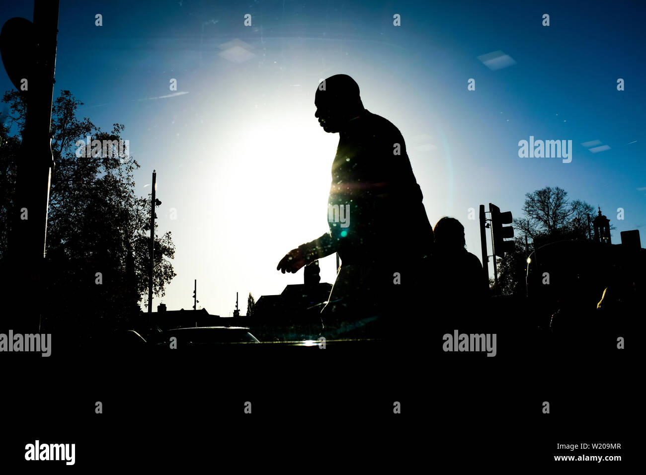 Silhouette of person of color walking, Brixton, London England Stock Photo