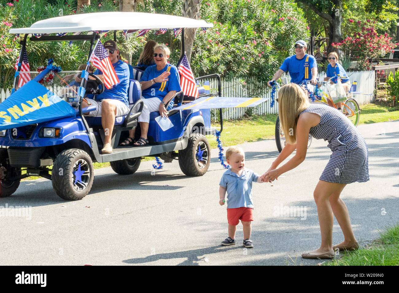 Sullivans Island South Carolina, USA. 4th July, 2019. Families take part in the annual Independence Day golf cart and bicycle parade July 4, 2019 in Sullivan's Island, South Carolina. The tiny affluent Sea Island beach community across from Charleston holds an outsized golf cart parade featuring more than 75 decorated carts. Credit: Planetpix/Alamy Live News Stock Photo