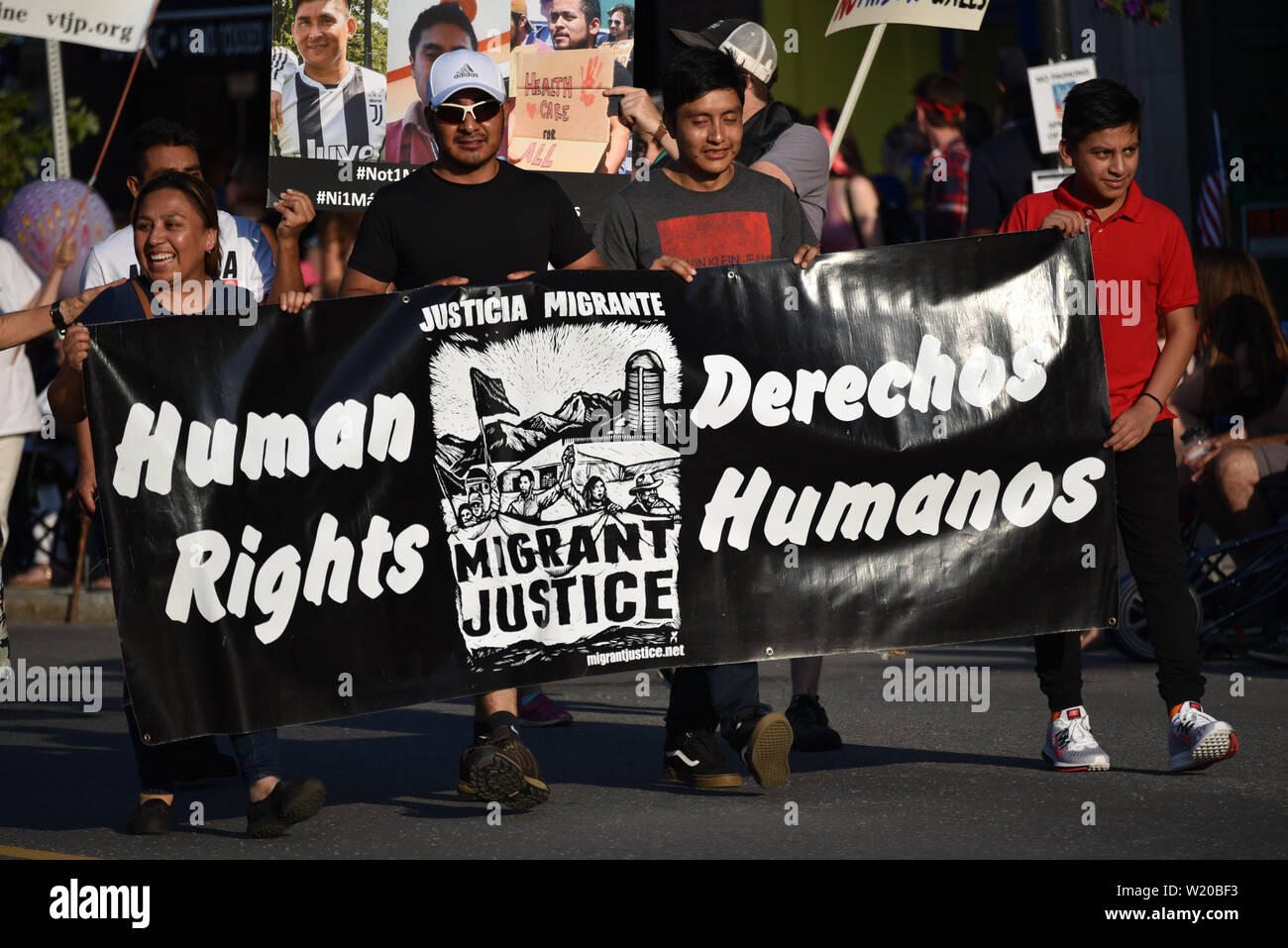 Migrant Justice (organization) supporters march in July 4 parade, held every July 3, Montpelier, VT, USA. Stock Photo