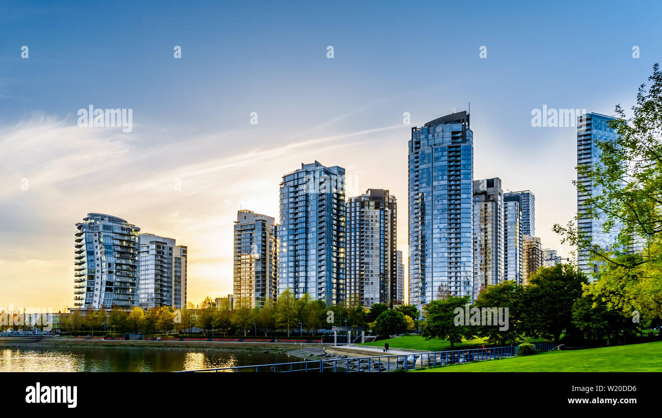 Sunset as the sun is setting behind modern Skyscrapers lining the skyline of Yaletown along False Creek Inlet of Vancouver, British Columbia, Canada Stock Photo