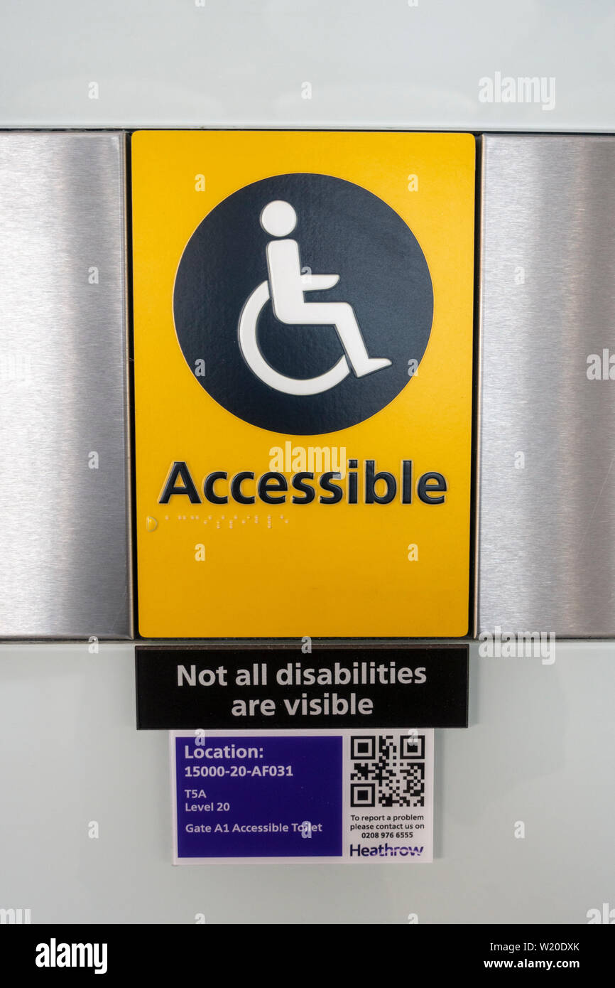 An accessible wheelchair sign with 'Not all disabilities are visible' notice in Terminal Five, London Heathrow Airport, UK. Stock Photo