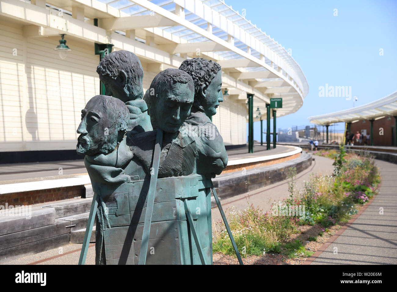 The sculpture 'Rug People' at Folkestone harbour train station restored as part of the Harbour Arm, in Kent, SE England, UK Stock Photo
