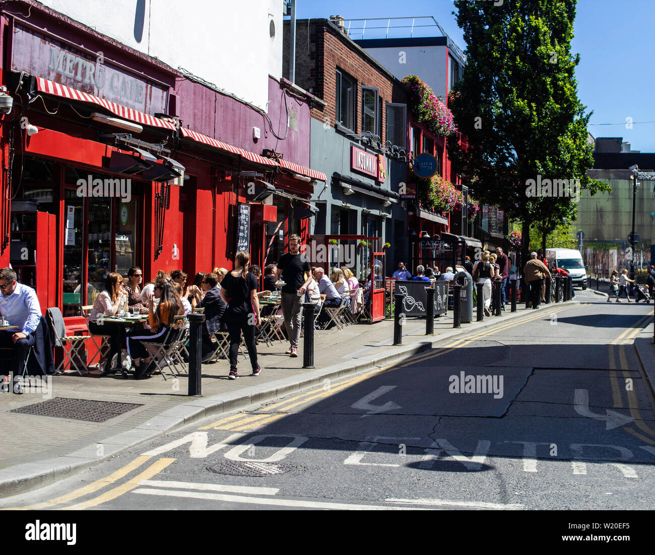 Dubliners enjoying the summer weather dining out in a city street. Stock Photo