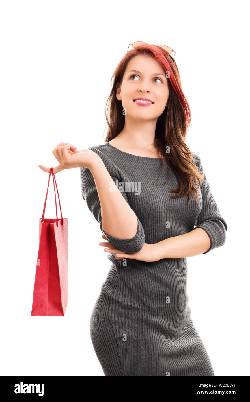 A portrait shot of a beautiful young girl in a dress, holding a ...