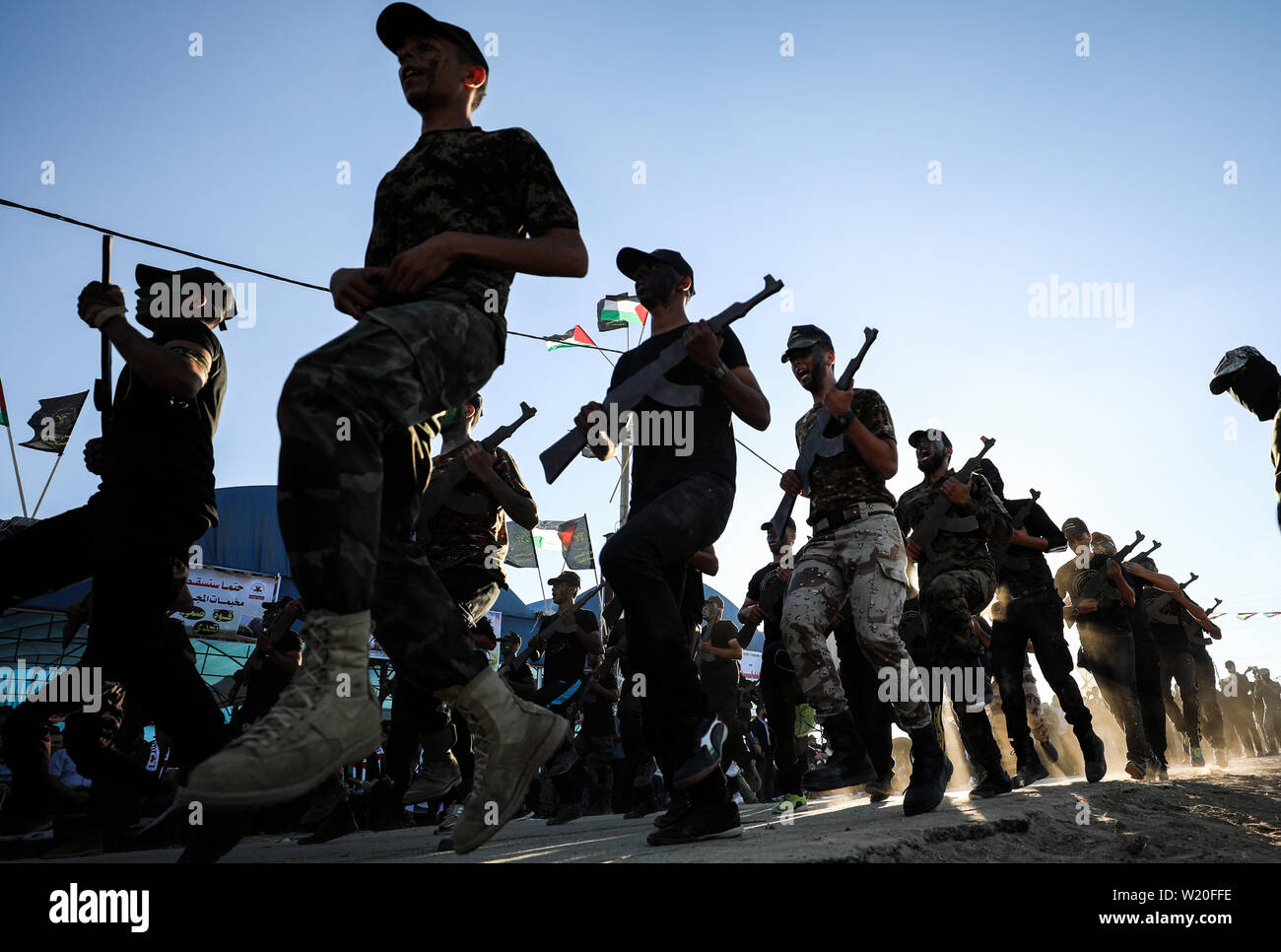 Gaza. 4th July, 2019. Palestinians carrying wooden rifles take part in a military graduation ceremony in Gaza City, July 4, 2019. Credit: Yasser Qudih/Xinhua/Alamy Live News Stock Photo