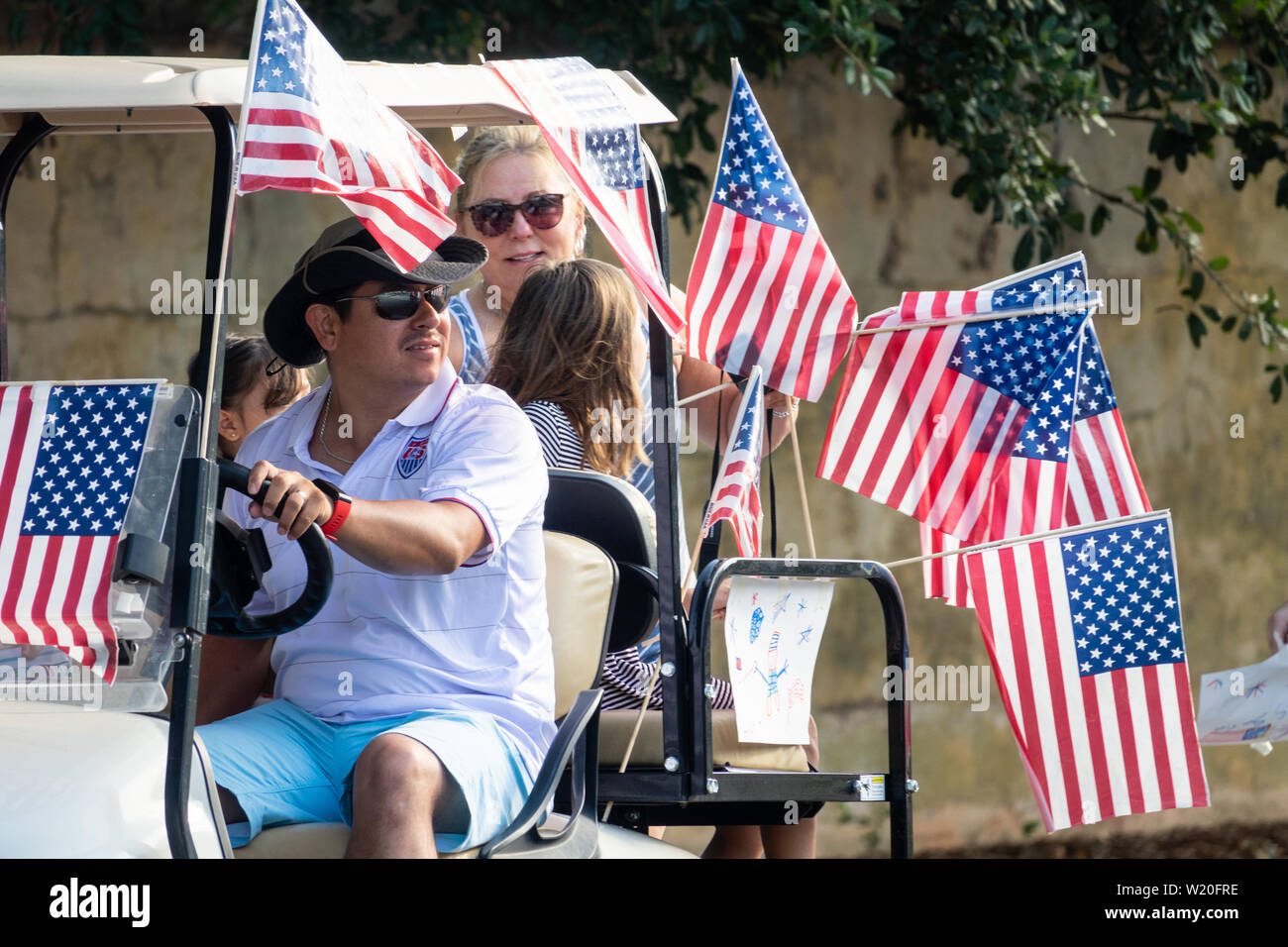 A golf cart float decorated with flags during the annual Independence Day golf cart and bicycle parade July 4, 2019 in Sullivan's Island, South Carolina. The tiny affluent Sea Island beach community across from Charleston holds an outsized golf cart parade featuring more than 75 decorated carts. Stock Photo